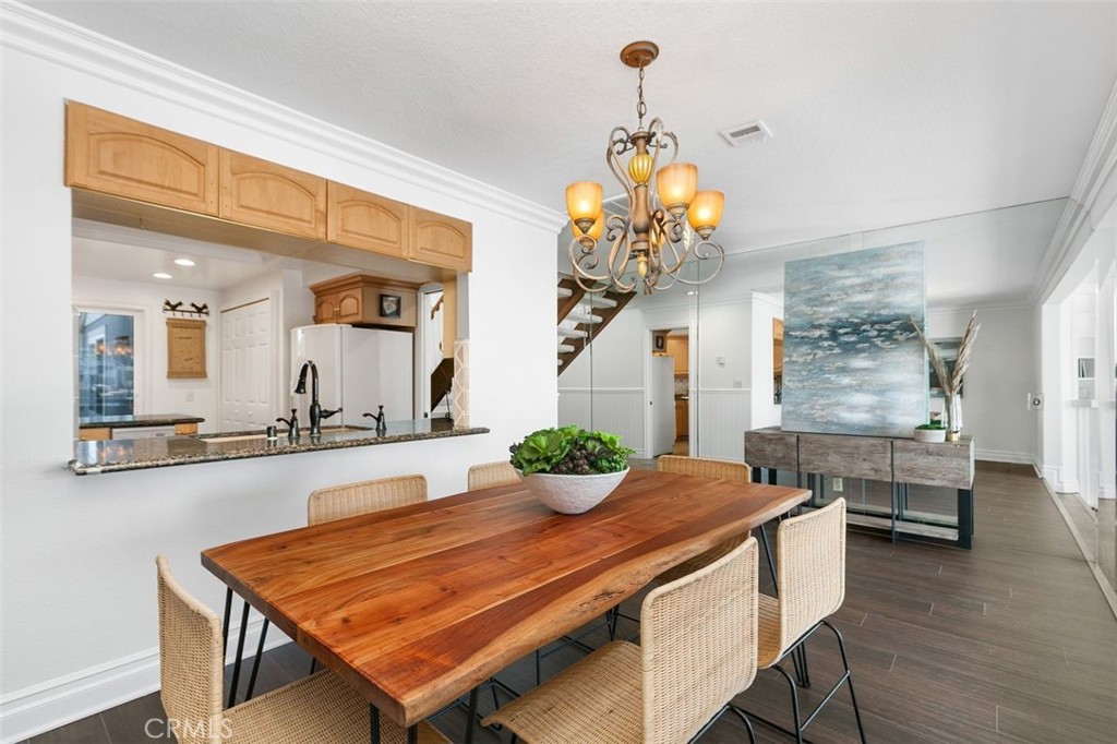 16117 St Croix Circle Huntington Beach, CA 92649 - Photo 18 of 45 a dining room with furniture and chandelier