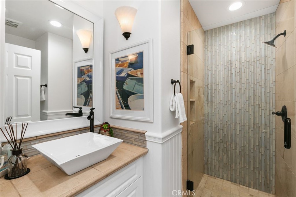 16117 St Croix Circle Huntington Beach, CA 92649 - Photo 22 of 45 a spacious bathroom with a shower sink and mirror