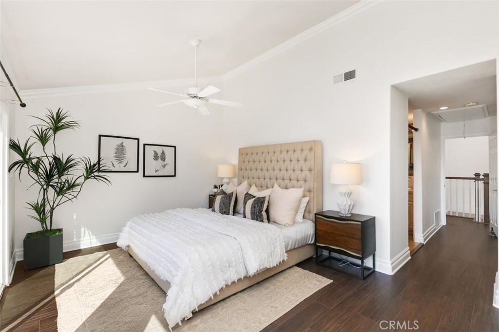 16117 St Croix Circle Huntington Beach, CA 92649 - Photo 24 of 45 a bedroom with a large bed and a potted plant