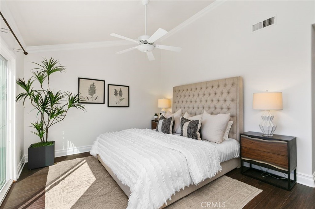16117 St Croix Circle Huntington Beach, CA 92649 - Photo 26 of 45 a bedroom with a large bed and a potted plant
