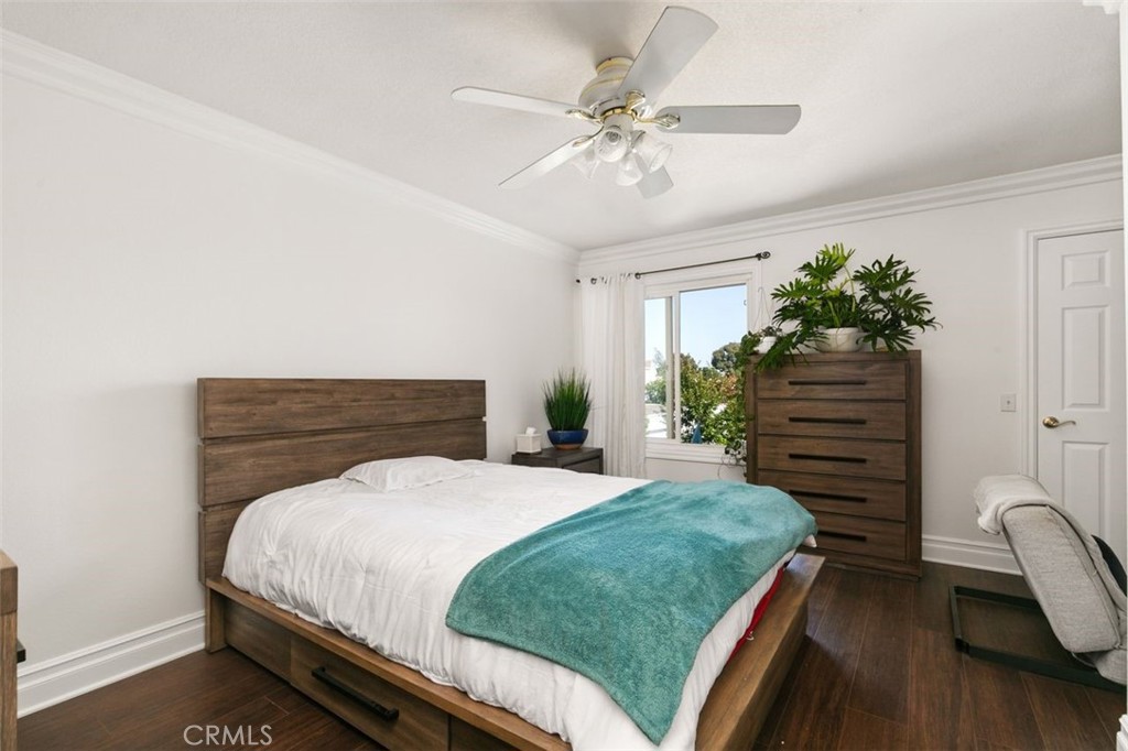 16117 St Croix Circle Huntington Beach, CA 92649 - Photo 30 of 45 a bedroom with a bed and a chandelier