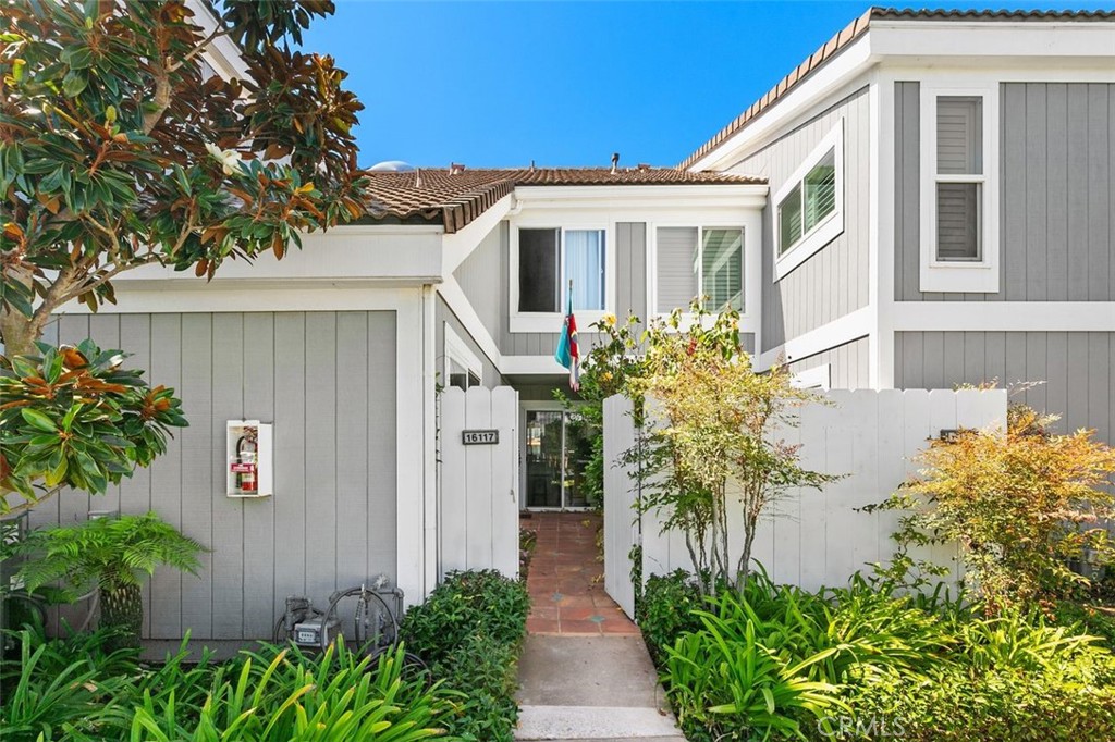 16117 St Croix Circle Huntington Beach, CA 92649 - Photo 3 of 45 a front view of a house with a yard