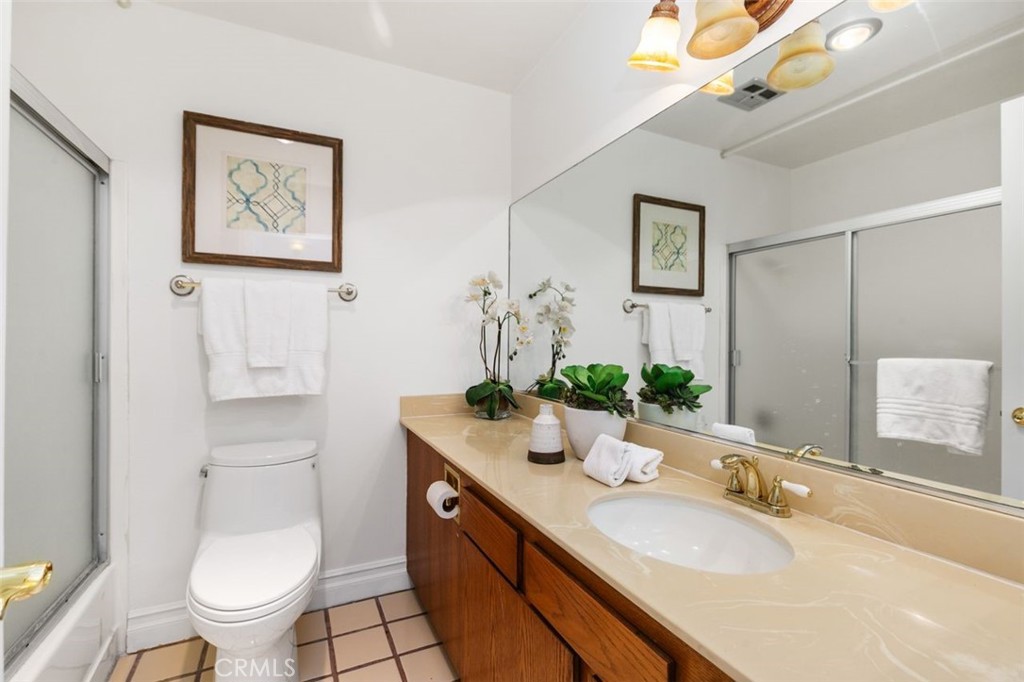 16117 St Croix Circle Huntington Beach, CA 92649 - Photo 31 of 45 a bathroom with a granite countertop toilet a sink and a mirror