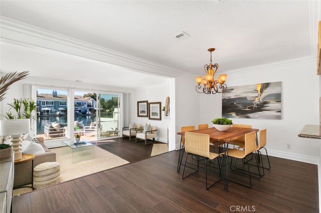 16117 St Croix Circle Huntington Beach, CA 92649 - Photo 5 of 45 a living room with dining table and wooden floor