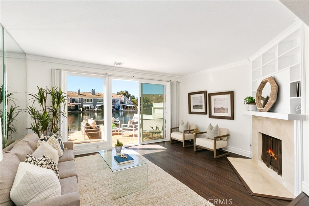 16117 St Croix Circle Huntington Beach, CA 92649 - Photo 6 of 45 a living room with furniture a large window and a fireplace