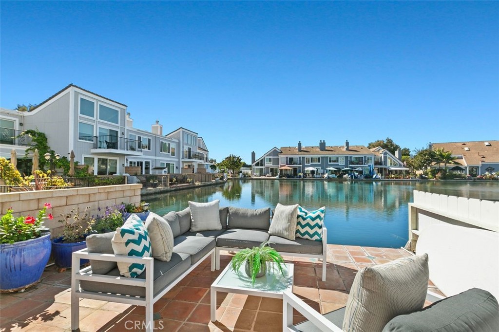 16117 St Croix Circle Huntington Beach, CA 92649 - Photo 10 of 45 a view of a lake with couches chairs and a potted plant