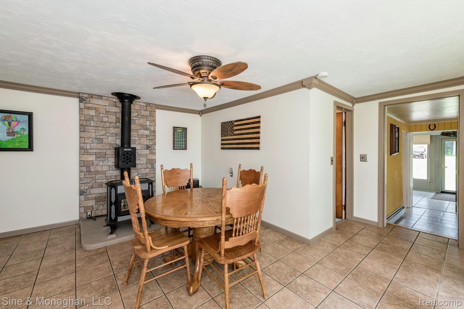 39716 Willow Road New Boston, MI 48164 - Photo 9 of 41 Dining room with wood stove, crown moulding