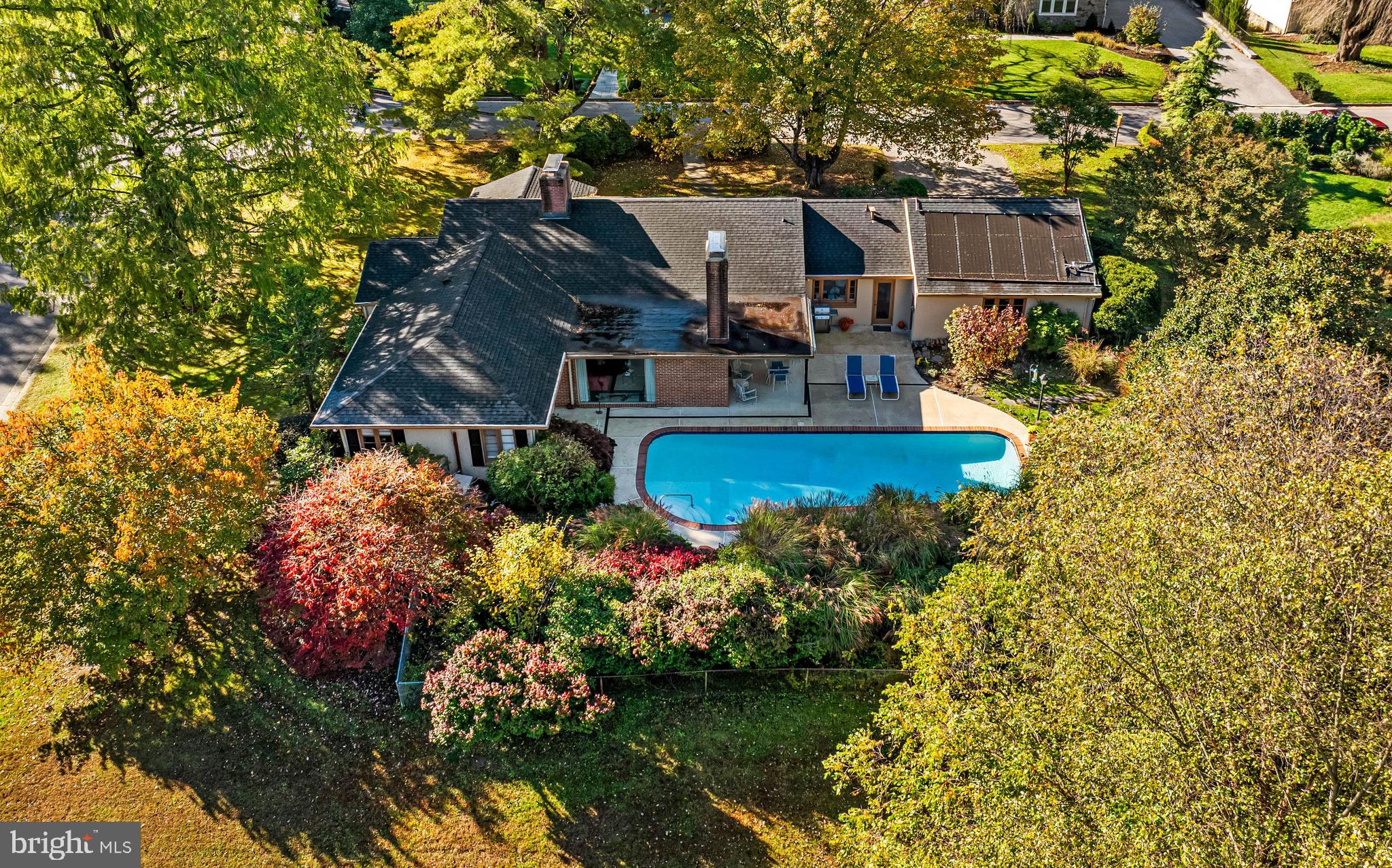 a view of a house with a yard and sitting area