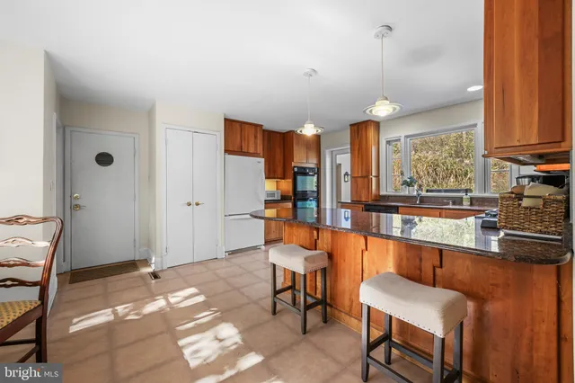 a very nice looking dining room with a large window and chandelier