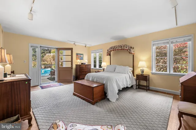 a spacious bedroom with a bed couch and a window