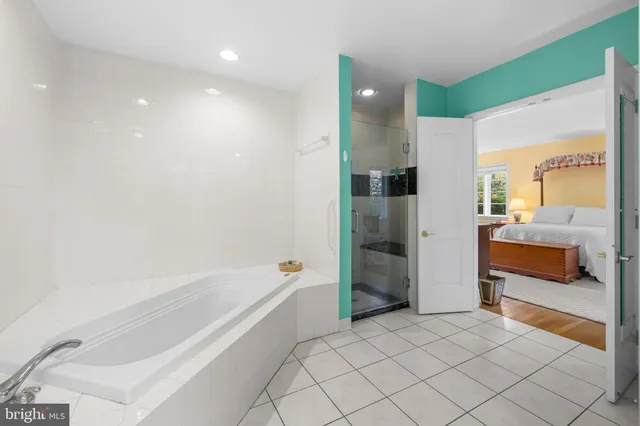 a bathroom with a bathtub and a shower