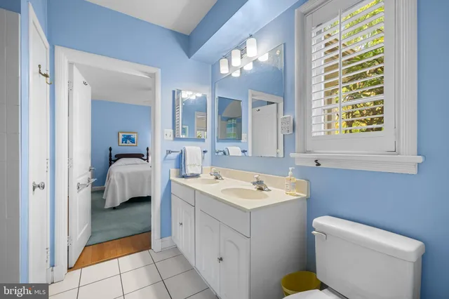 a bathroom with a sink toilet and mirror