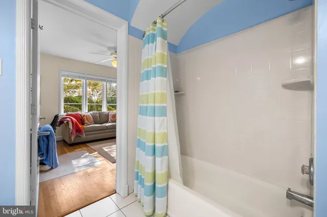 a en suite bathroom with a tub shower and window
