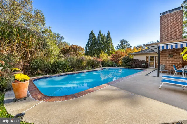 a view of a patio with a table and chairs and potted plants
