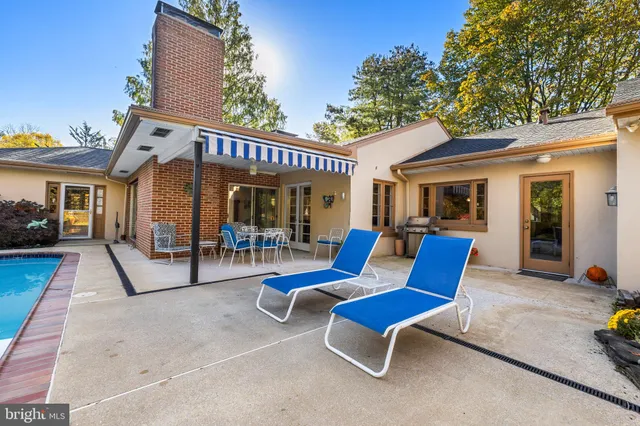 a backyard of a house with table and chairs