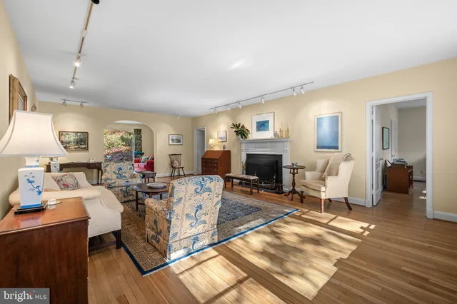 a living room with furniture a fireplace and a table