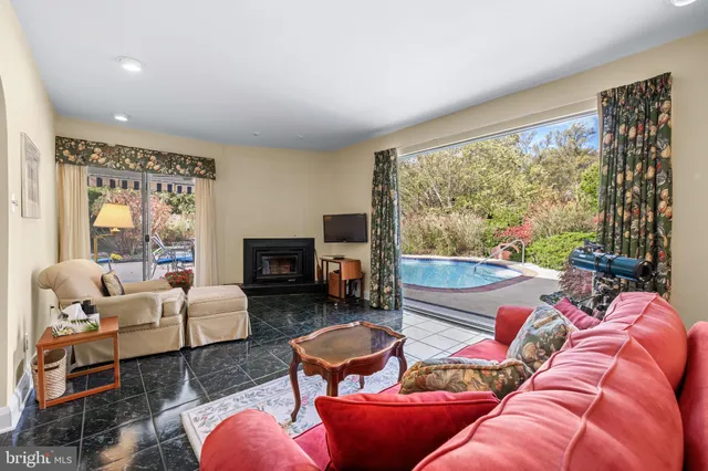 a living room with furniture fireplace and a large window