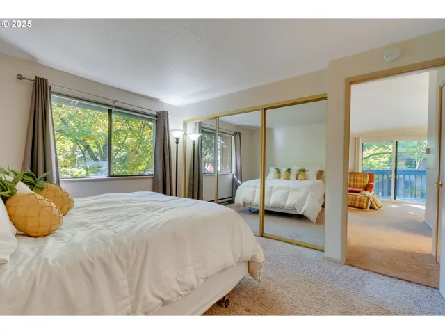 a bedroom with a bed and a large window