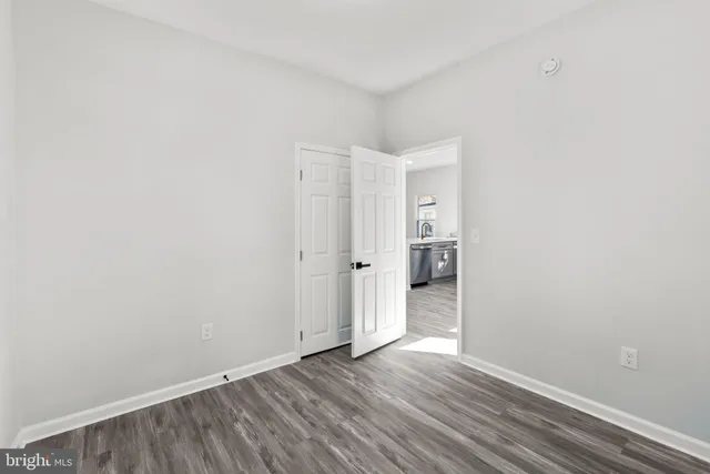 a view of an empty room and wooden floor