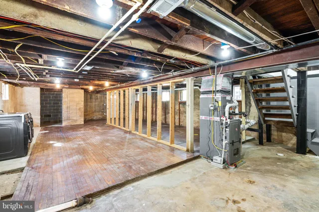 a utility room with dryer washer and a view of living room