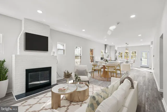 a living room with furniture a fireplace and a flat screen tv