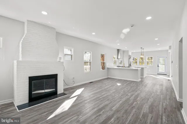 a view of a kitchen with a sink and a fireplace
