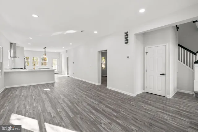 a view of a kitchen with wooden floor and a sink