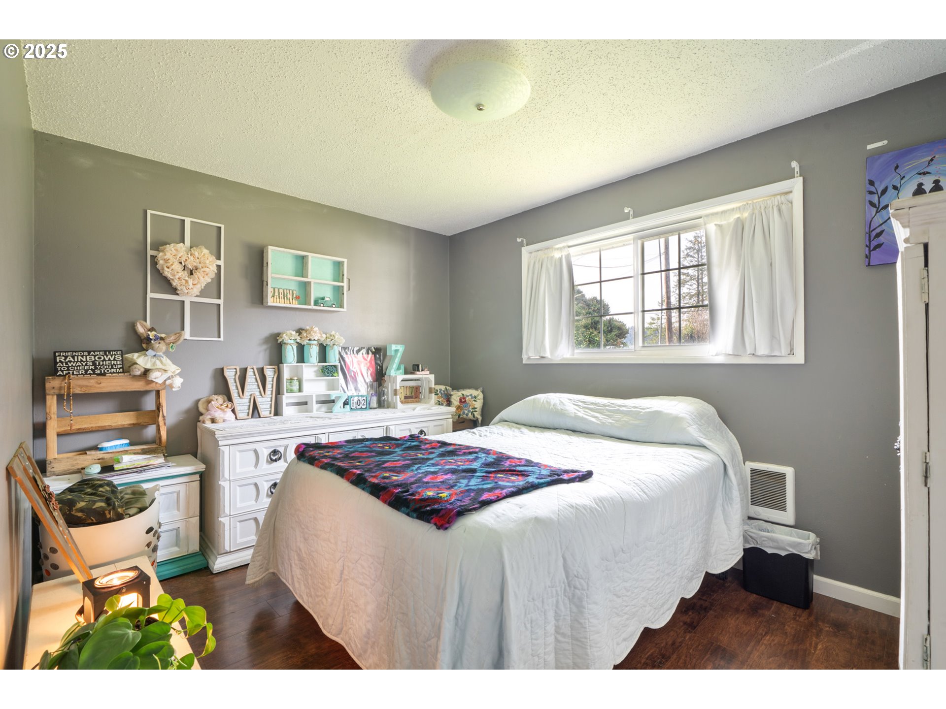 3195 Fitzpatrick Road Tillamook, OR 97141 - Photo 15 of 31 a bedroom with a bed a table and chair