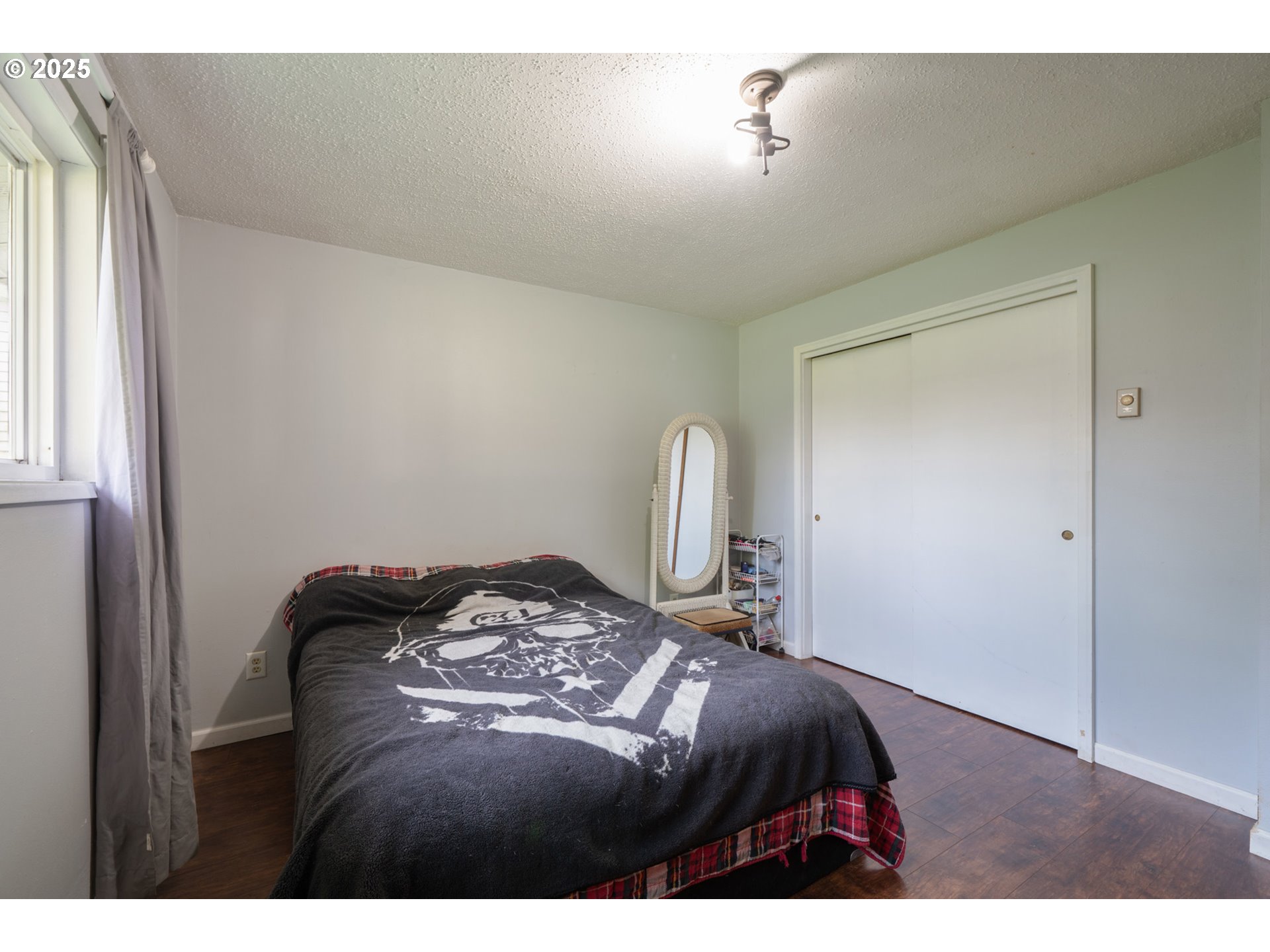 3195 Fitzpatrick Road Tillamook, OR 97141 - Photo 18 of 31 a bedroom with a bed and a mirror