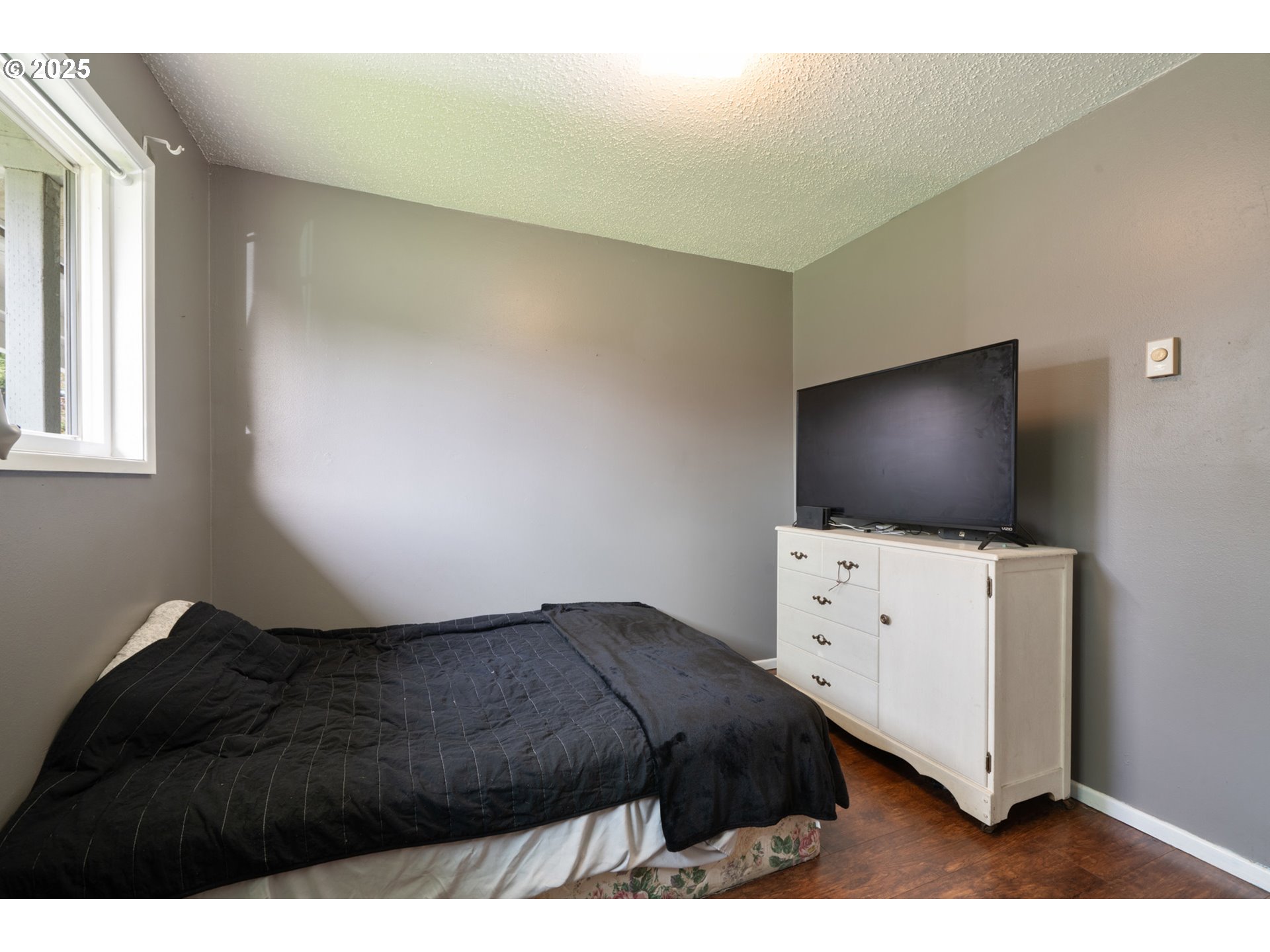 3195 Fitzpatrick Road Tillamook, OR 97141 - Photo 21 of 31 a bedroom with a bed and flat screen tv