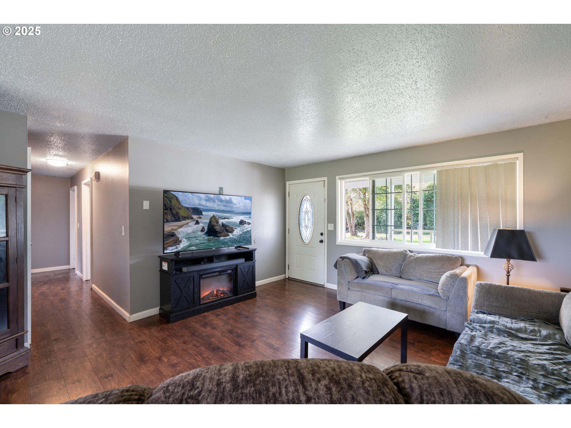 3195 Fitzpatrick Road Tillamook, OR 97141 - Photo 7 of 31 a living room with furniture and a flat screen tv