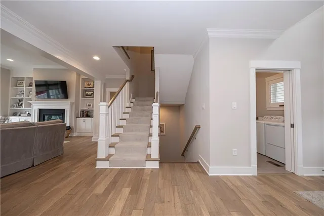 a view of a livingroom with wooden floor and a fireplace