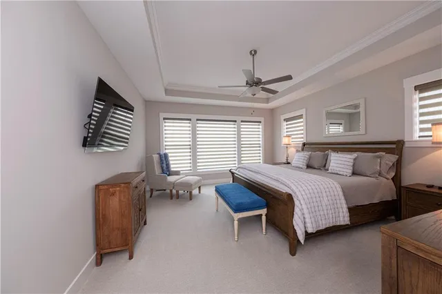 a spacious bedroom with a bed and a chandelier