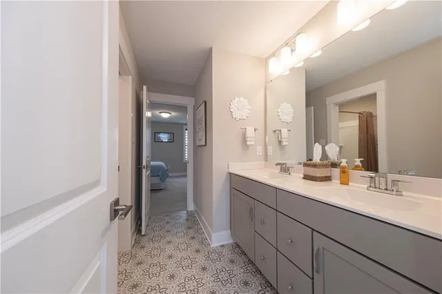 a en suite bathroom with a sink a mirror and a shower