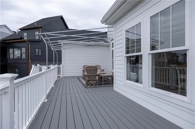 a view of a house with a barbeque and wooden floor
