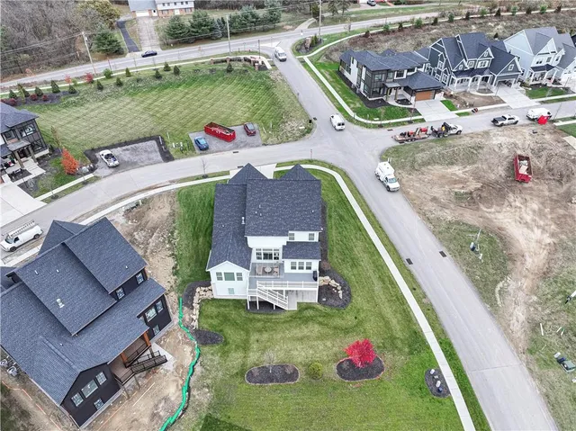 an aerial view of a house with a garden and swimming pool