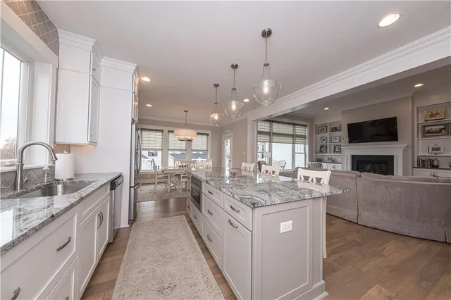 a large white kitchen with a large window