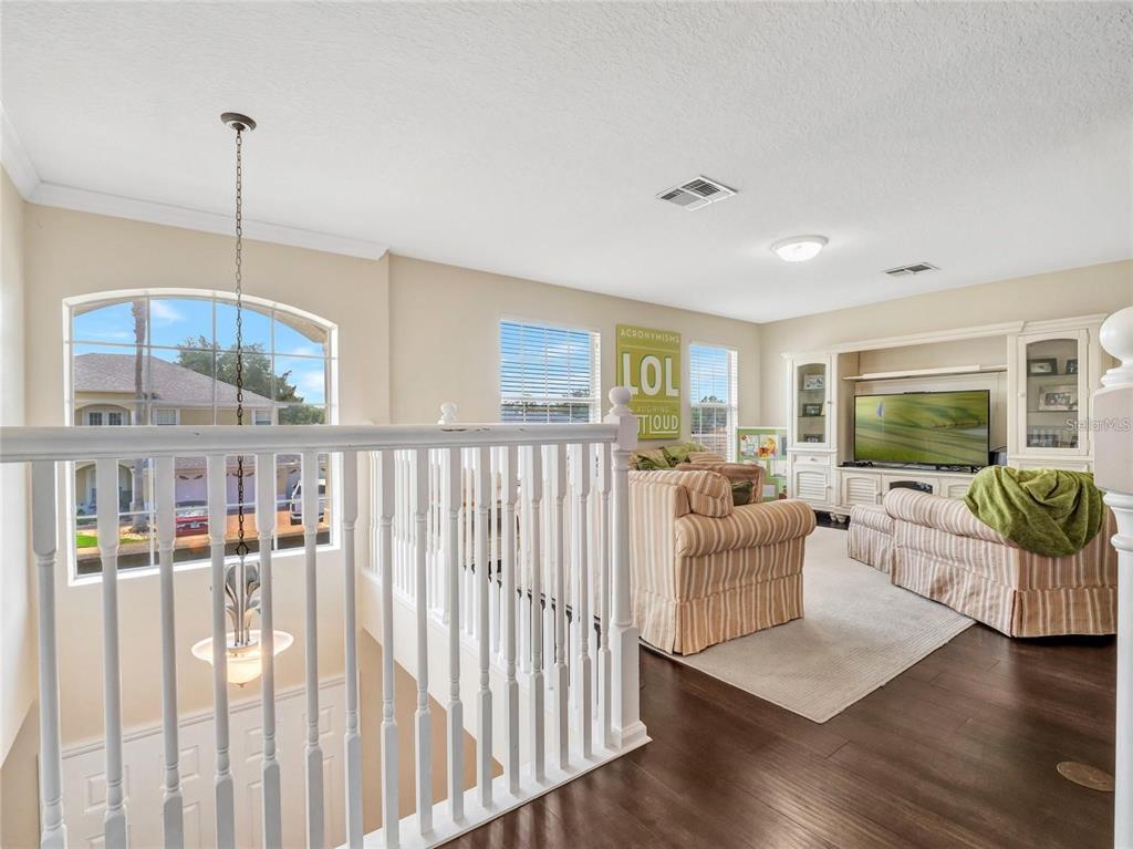 10023 Ians Ridge Road Orlando, FL 32832 - Photo 23 of 60 a living room with furniture and a wooden floor