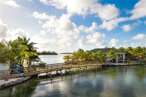 a view of swimming pool with outdoor seating and lake view