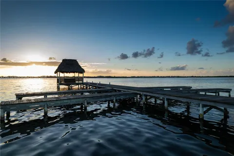 an aerial view of a house with a yard and lake view
