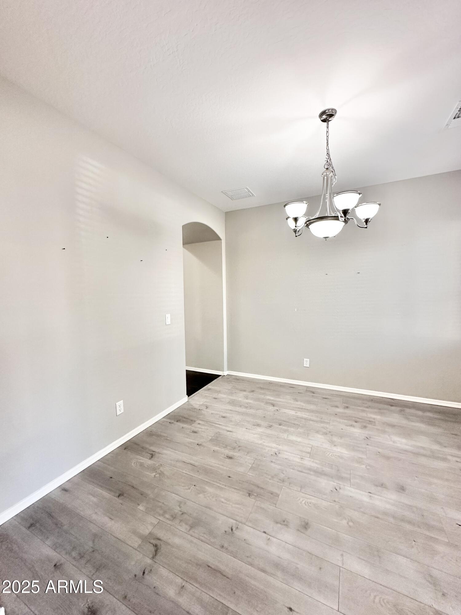 16511 West Tether Trail Surprise, AZ 85387 - Photo 17 of 88 a view of empty room with wooden floor