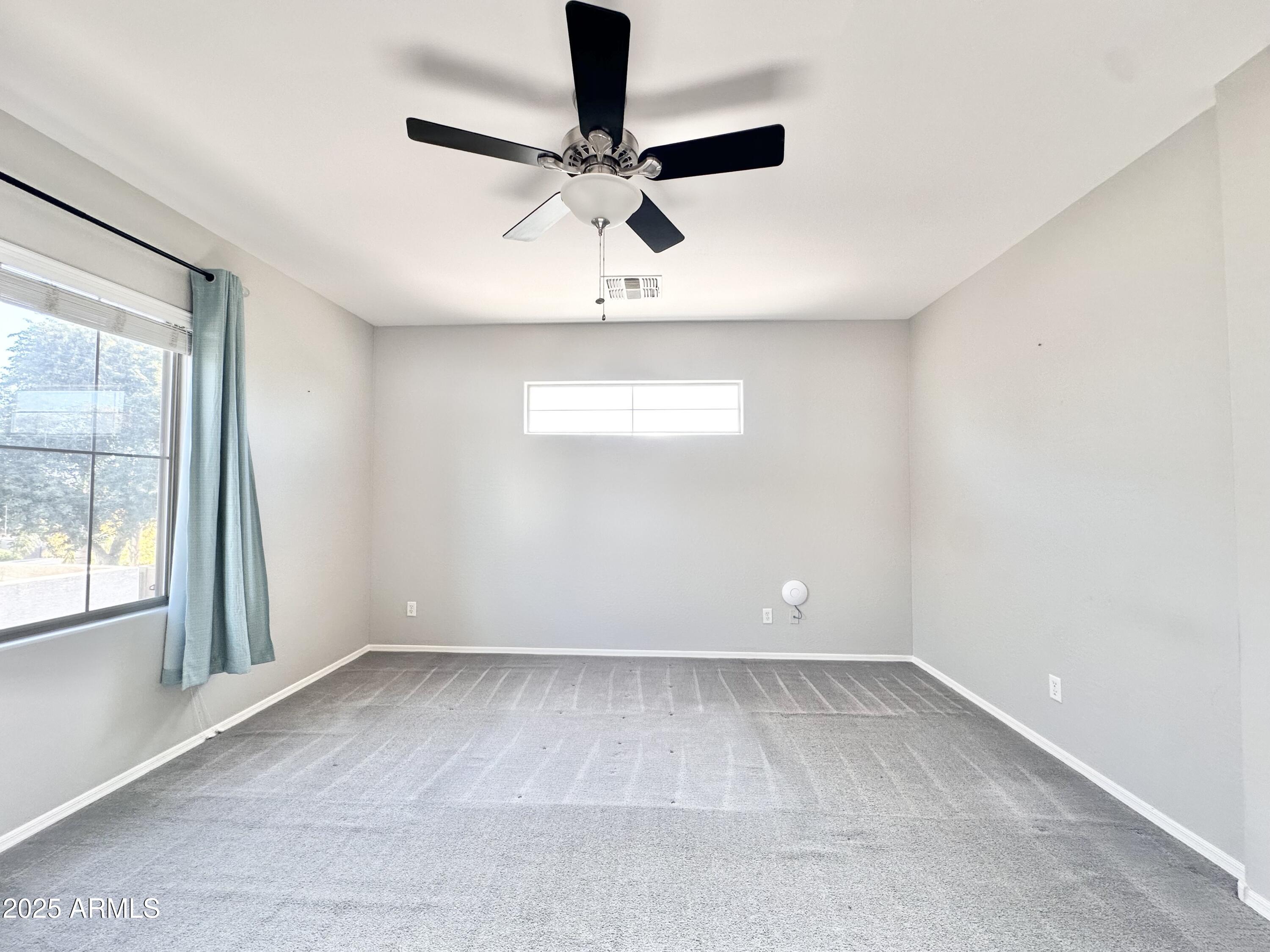 16511 West Tether Trail Surprise, AZ 85387 - Photo 46 of 88 an empty room with windows and fan