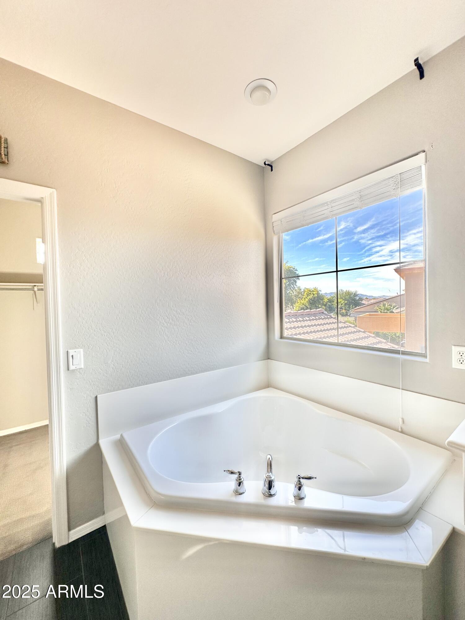 16511 West Tether Trail Surprise, AZ 85387 - Photo 51 of 88 a white bath tub sitting next to a window