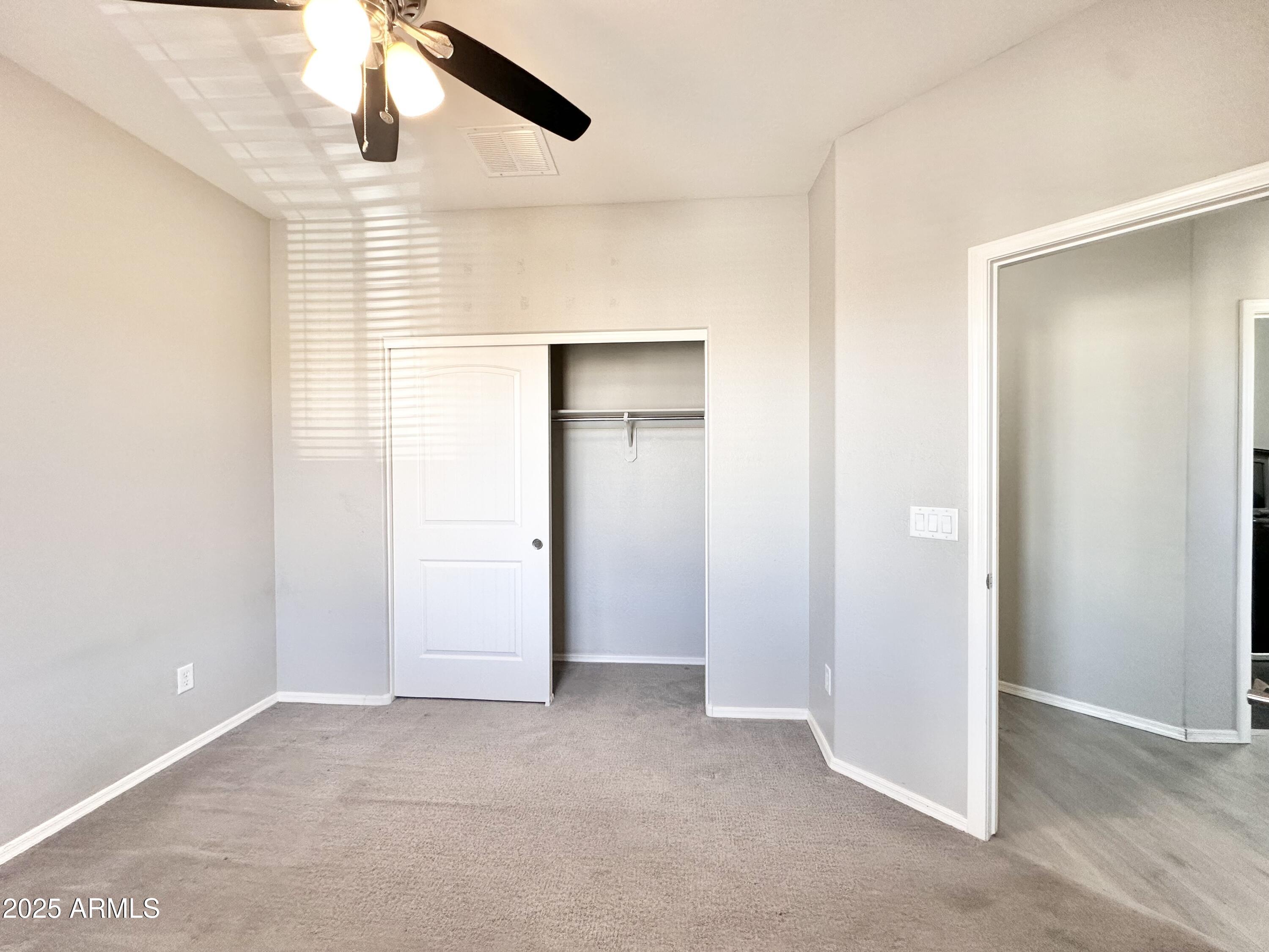 16511 West Tether Trail Surprise, AZ 85387 - Photo 63 of 88 an empty room with windows and closet