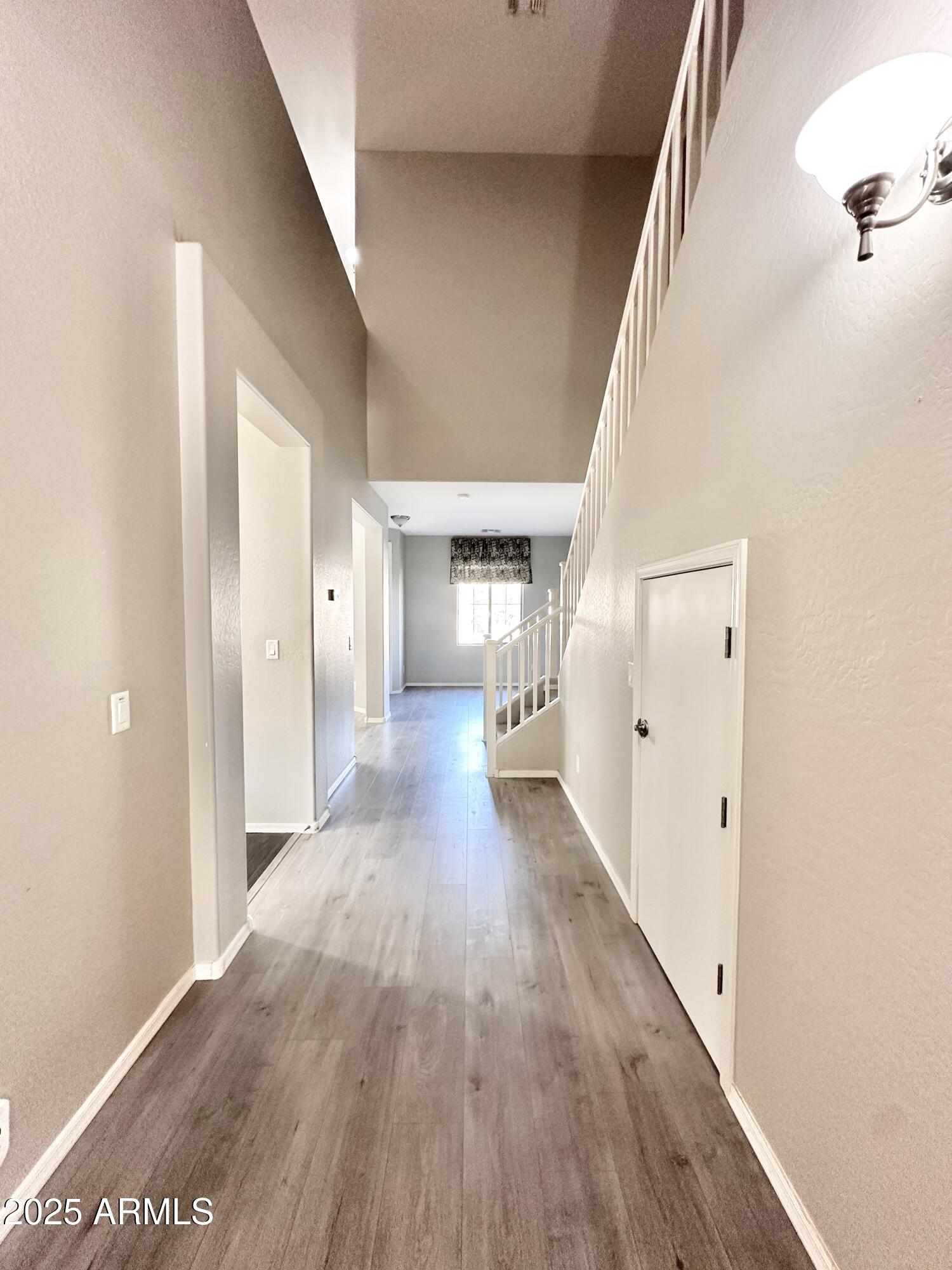 16511 West Tether Trail Surprise, AZ 85387 - Photo 84 of 88 a view of a hallway with wooden floor