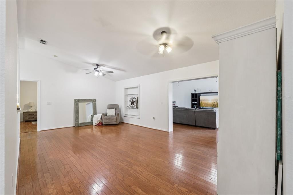 12315 Fort King Road Dade City, FL 33525 - Photo 14 of 77 a view of a livingroom with furniture wooden floor and a ceiling fan