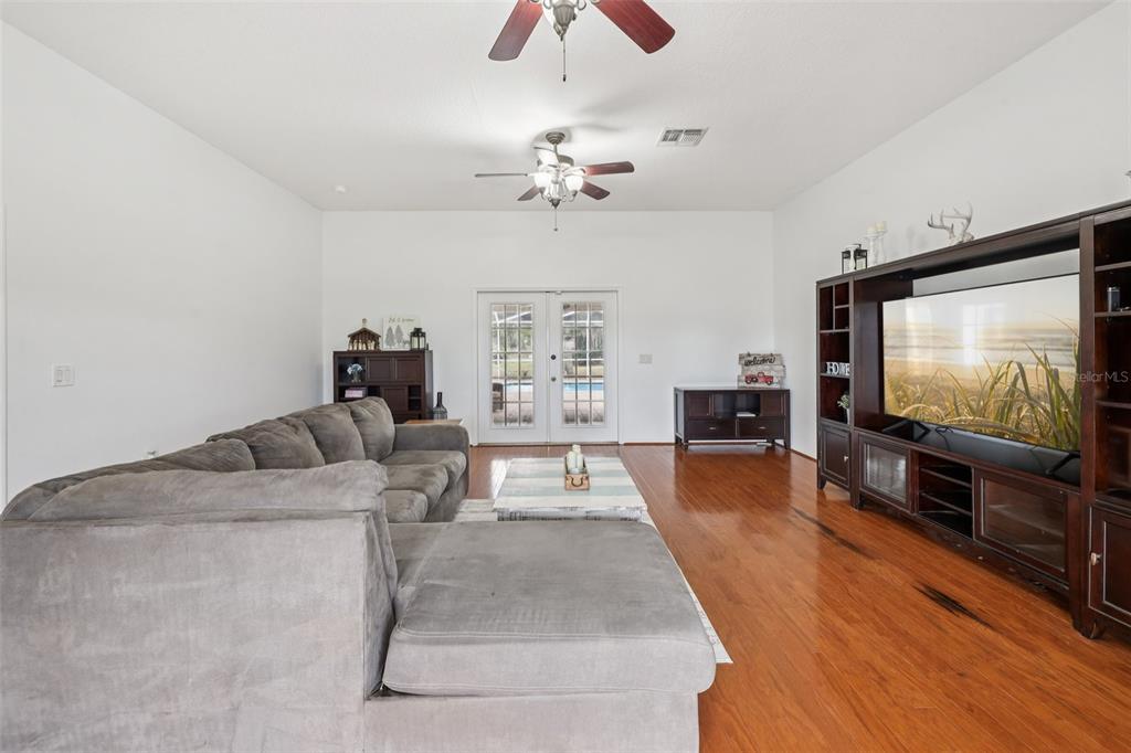 12315 Fort King Road Dade City, FL 33525 - Photo 18 of 77 a living room with furniture and a flat screen tv