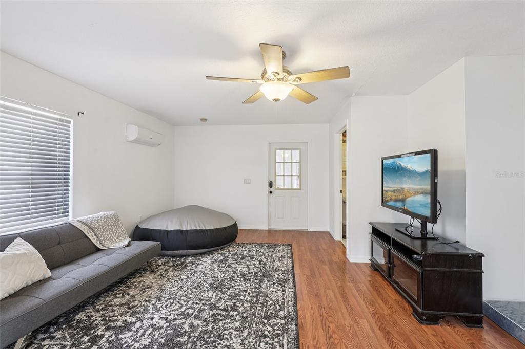 12315 Fort King Road Dade City, FL 33525 - Photo 24 of 77 a living room with furniture and a wooden floor