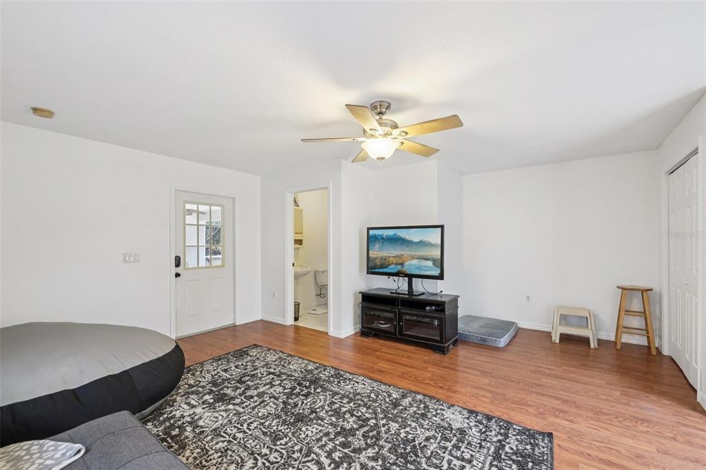 12315 Fort King Road Dade City, FL 33525 - Photo 26 of 77 a bedroom with furniture and a wooden floor