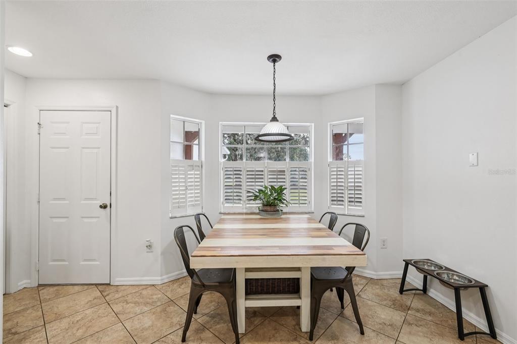12315 Fort King Road Dade City, FL 33525 - Photo 28 of 77 a view of a dining room with furniture window and wooden floor